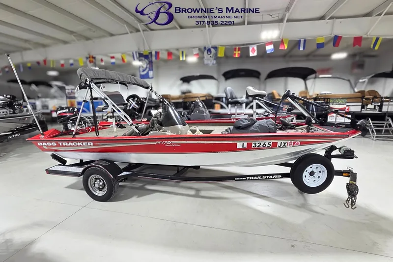 The Image of 2005 Tracker Pro Team 175 bass boat on trailer in showroom. - 1