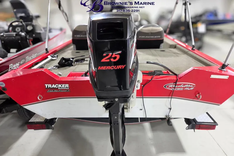 Slide: The Image of 2005 Tracker Pro Team 175 boat with Mercury 25 engine, displayed indoors. - 12
