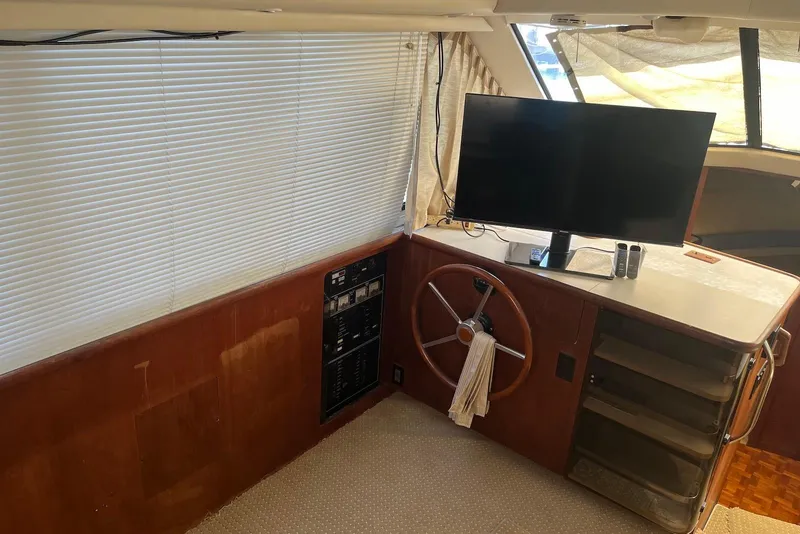 Slide: The Image of Interior of 1992 Carver 33 Aft Cabin Motor Yacht with helm, TV, and control panel. - 10