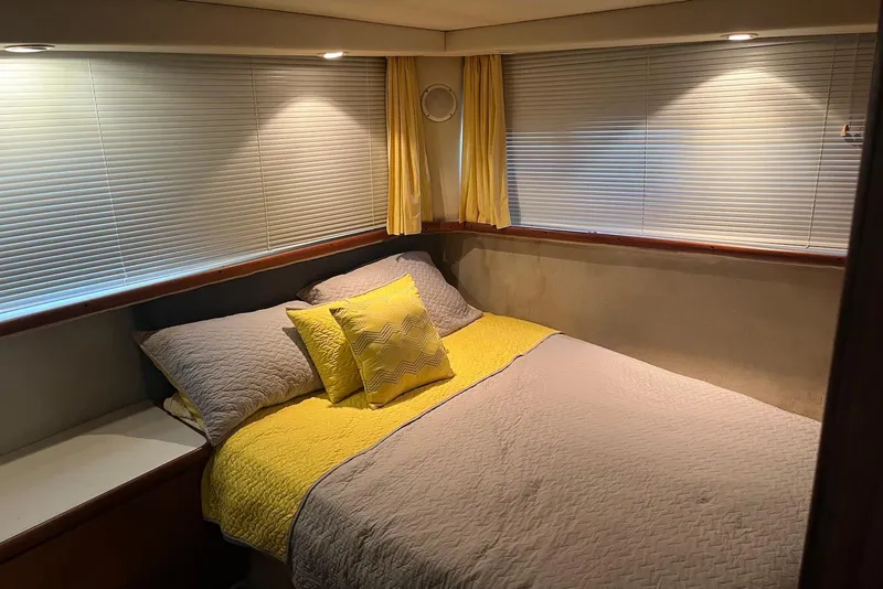 Slide: The Image of Cozy bedroom in 1992 Carver 33 Aft Cabin Motor Yacht with yellow accents. - 11