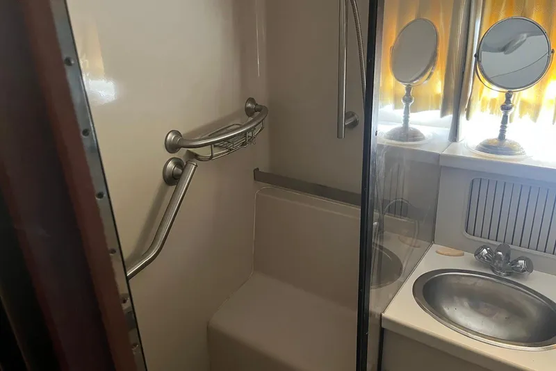 Slide: The Image of Bathroom interior of 1992 Carver 33 Aft Cabin Motor Yacht with sink and mirrors. - 13