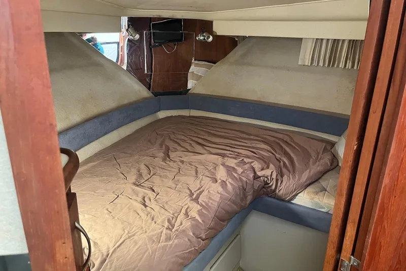 Slide: The Image of 1992 Carver 33 Aft Cabin Motor Yacht interior cabin with bed and wood paneling. - 14