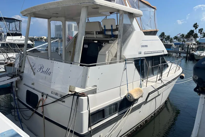 Slide: The Image of 1992 Carver 33 Aft Cabin Motor Yacht docked at marina, sunny day. - 2