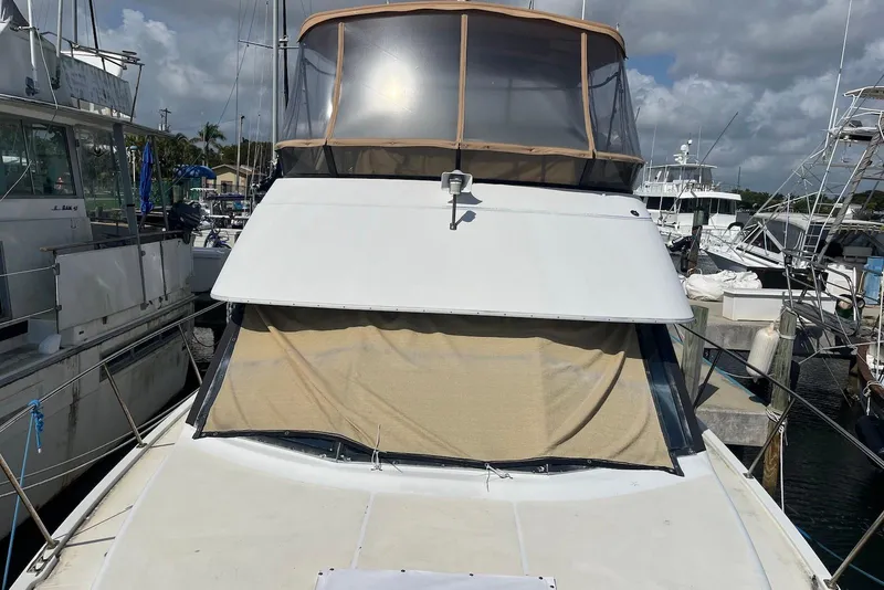 Slide: The Image of 1992 Carver 33 Aft Cabin Motor Yacht docked at marina under cloudy sky. - 3