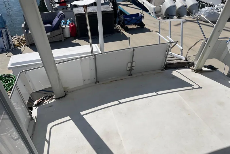 Slide: The Image of 1992 Carver 33 Aft Cabin Motor Yacht deck with marina view and docked boats. - 6