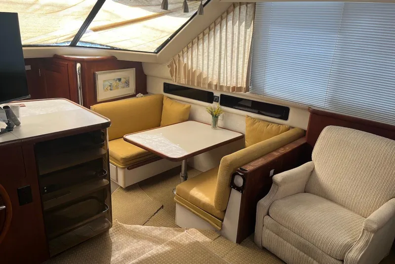 Slide: The Image of Interior of 1992 Carver 33 Aft Cabin Motor Yacht with cozy seating and dining area. - 7