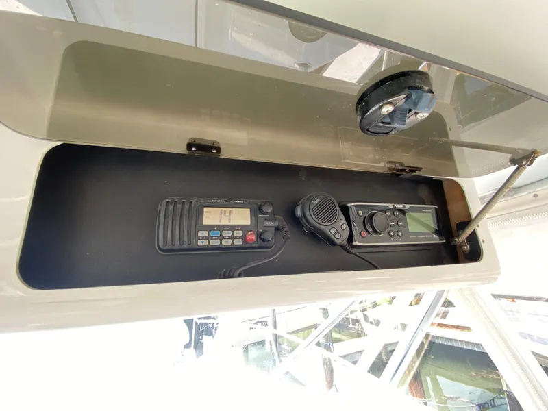 Slide: The Image of Storage compartment with communication devices on a 1995 L&H 33 boat. - 20