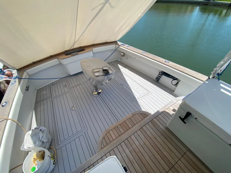 Slide: The Image of Open deck of 1995 L&H 33 boat with wooden flooring and seating. - 24