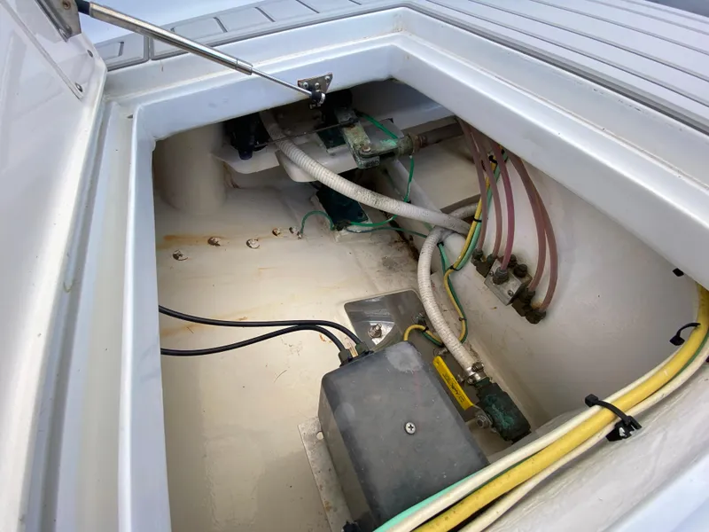 Slide: The Image of Open compartment of 1995 L&H 33 boat showing wiring and hoses. - 42