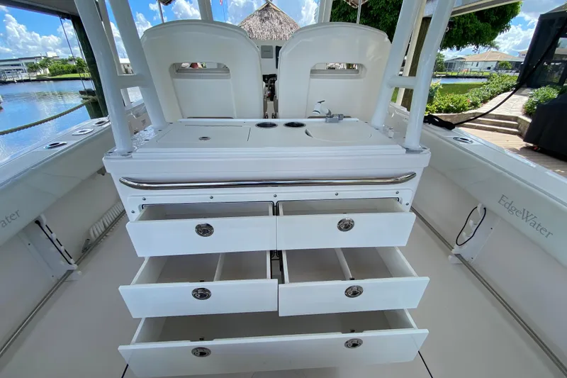 Slide: The Image of 2015 Edgewater 320CC boat interior with open storage drawers and sink. - 11