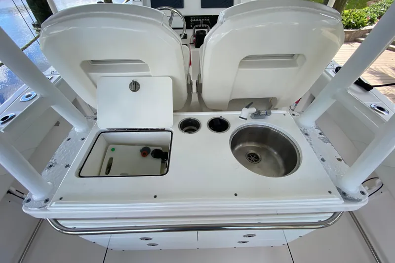 Slide: The Image of Edgewater 320CC 2015 boat interior with sink and storage compartments. - 12