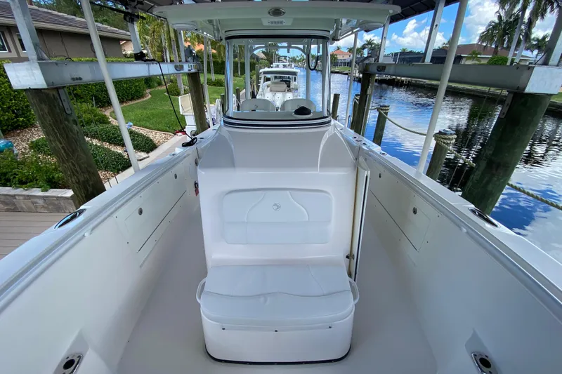 Slide: The Image of 2015 Edgewater 320CC boat interior, docked by a scenic canal. - 16