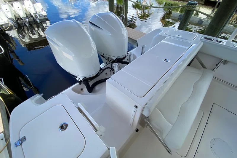 Slide: The Image of 2015 Edgewater 320CC boat with dual outboard engines and white seating area. - 20