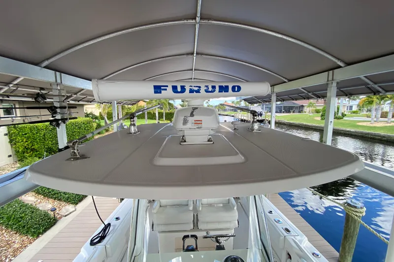 Slide: The Image of 2015 Edgewater 320CC boat with Furuno radar, docked under a canopy. - 25