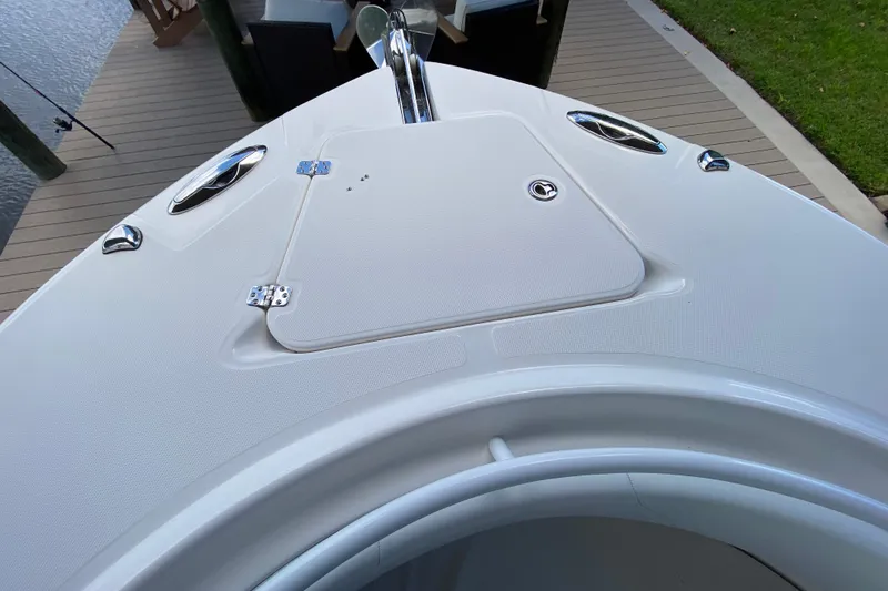 Slide: The Image of Bow of 2015 Edgewater 320CC boat docked, featuring sleek design and stainless steel fittings. - 29