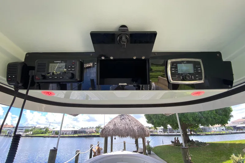 Slide: The Image of 2015 Edgewater 320CC boat dashboard with Garmin and Polk audio systems. - 32
