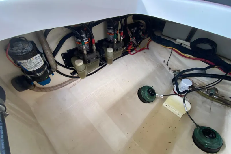 Slide: The Image of 2015 Edgewater 320CC boat interior showing pumps and wiring setup. - 34