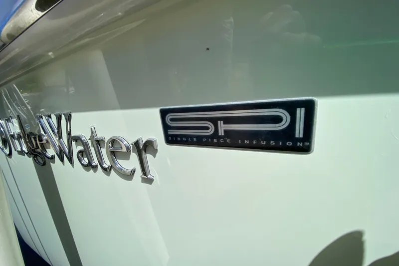 Slide: The Image of 2015 Edgewater 320CC boat with SPI logo, showcasing Single Piece Infusion technology. - 7