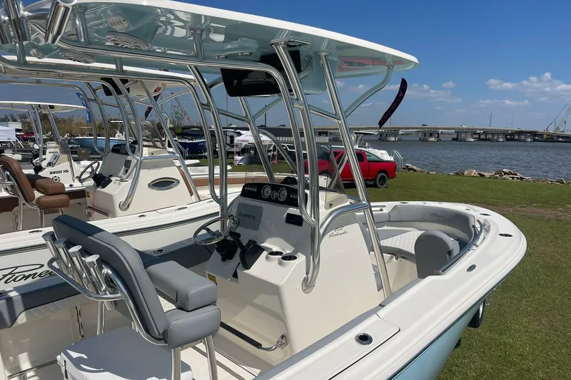 Slide: The Image of 2026 Pioneer 202 Islander boat displayed near a waterfront, showcasing sleek design and modern features. - 8