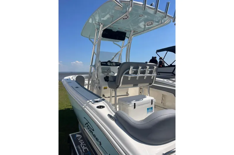 Slide: The Image of 2026 Pioneer 202 Islander boat with T-top and seating, docked by the water. - 9