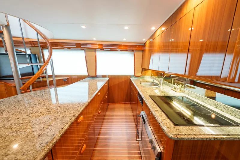 Slide: The Image of Luxurious kitchen interior of 2008 Viking 68 Skybridge yacht with granite countertops and wooden cabinetry. - 12