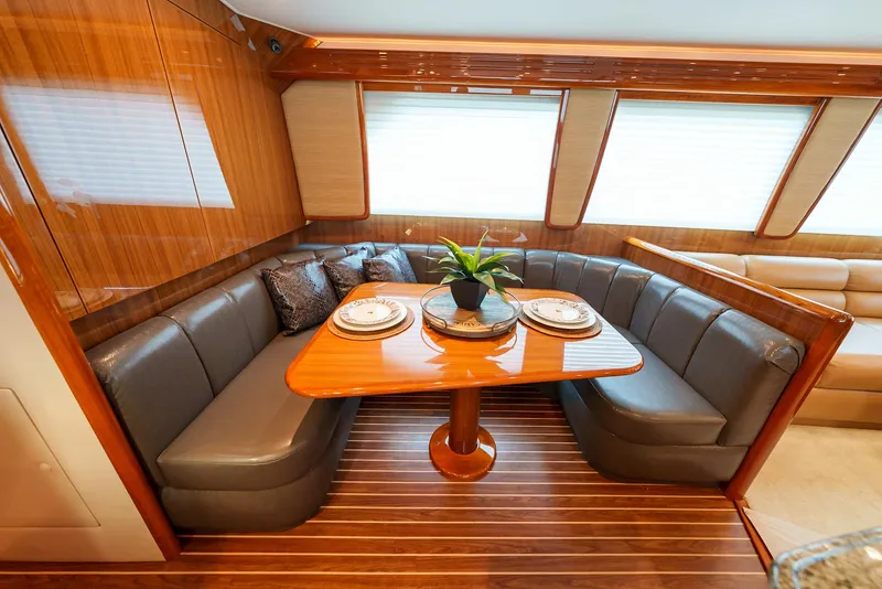 Slide: The Image of Luxurious dining area in 2008 Viking 68 Skybridge yacht with leather seating and wooden table. - 17