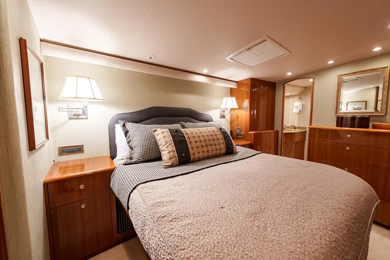 Slide: The Image of Luxurious bedroom interior of 2008 Viking 68 Skybridge yacht with elegant bedding and wooden furnishings. - 2