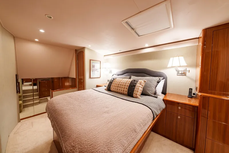 Slide: The Image of Luxurious bedroom interior of 2008 Viking 68 Skybridge yacht with plush bedding and wooden cabinetry. - 20