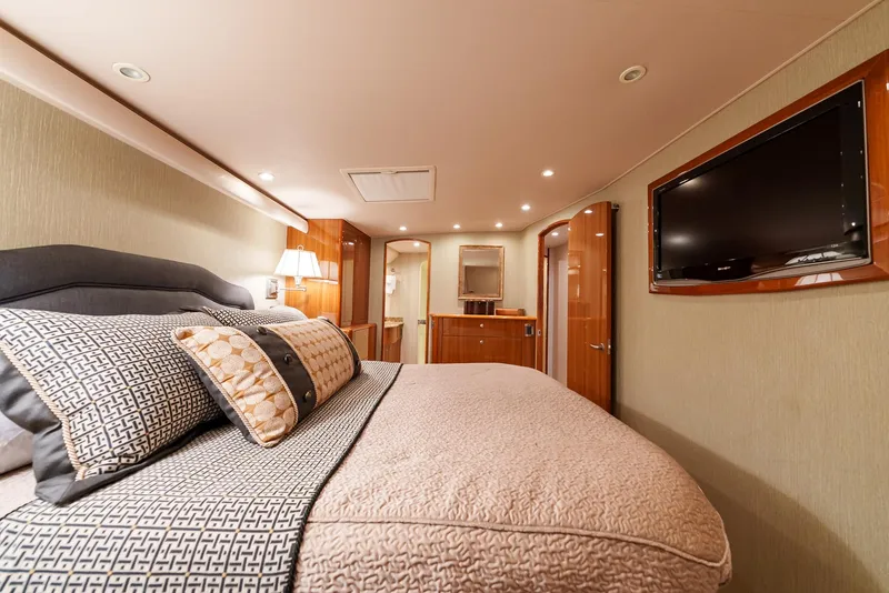 Slide: The Image of Luxurious bedroom interior of 2008 Viking 68 Skybridge yacht with plush bedding and flat-screen TV. - 21