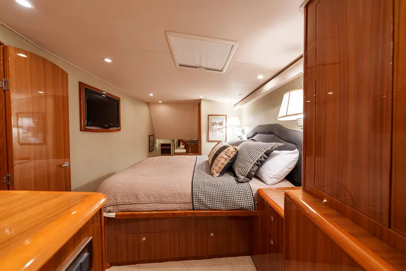 Slide: The Image of Luxurious bedroom interior of 2008 Viking 68 Skybridge yacht with wood finishes and modern amenities. - 23