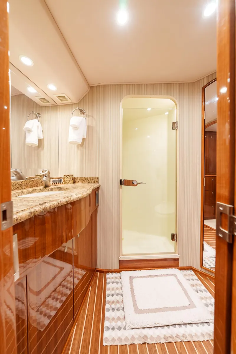 Slide: The Image of Luxurious bathroom in 2008 Viking 68 Skybridge yacht with granite countertop and glass shower. - 26