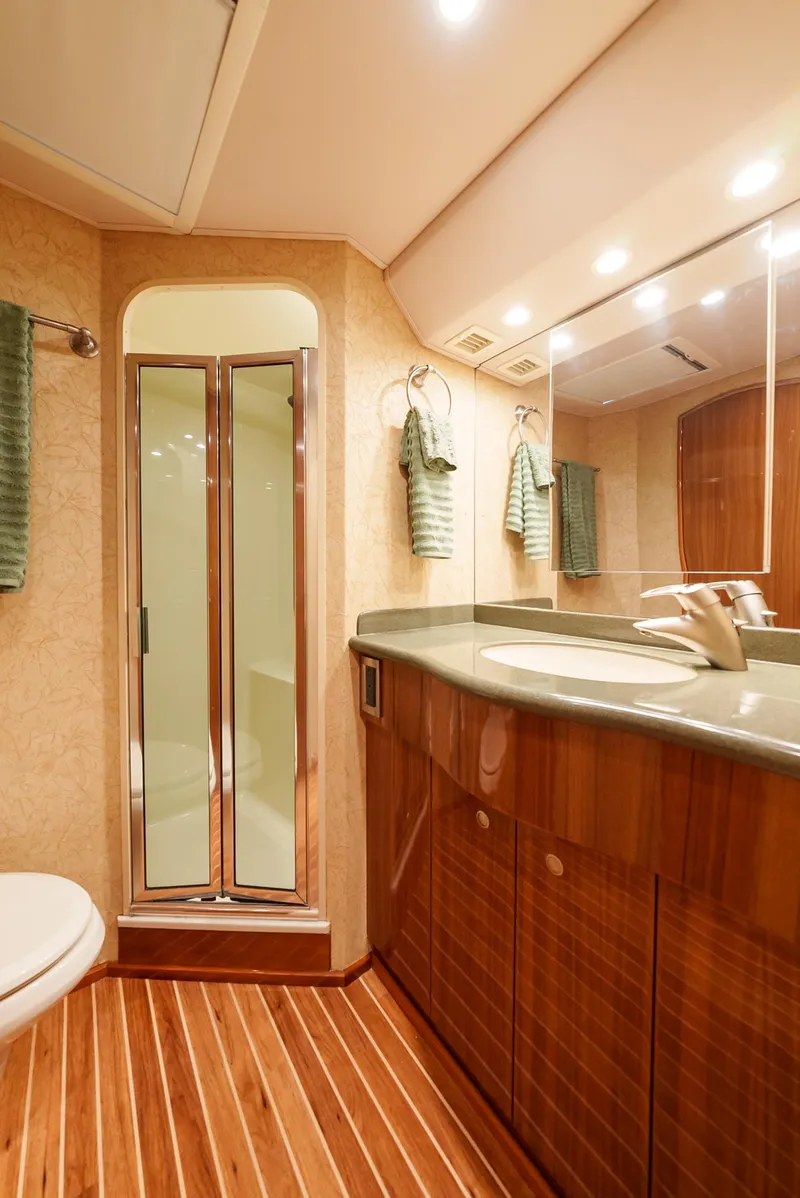 Slide: The Image of Luxurious bathroom in a 2008 Viking 68 Skybridge yacht with wooden cabinetry and modern fixtures. - 27
