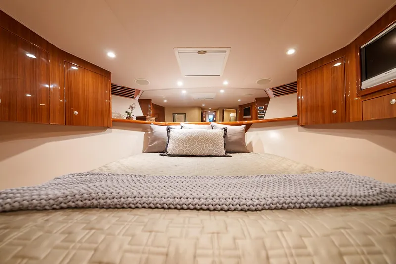 Slide: The Image of Luxurious bedroom interior of 2008 Viking 68 Skybridge yacht with cozy bedding and wooden cabinets. - 28