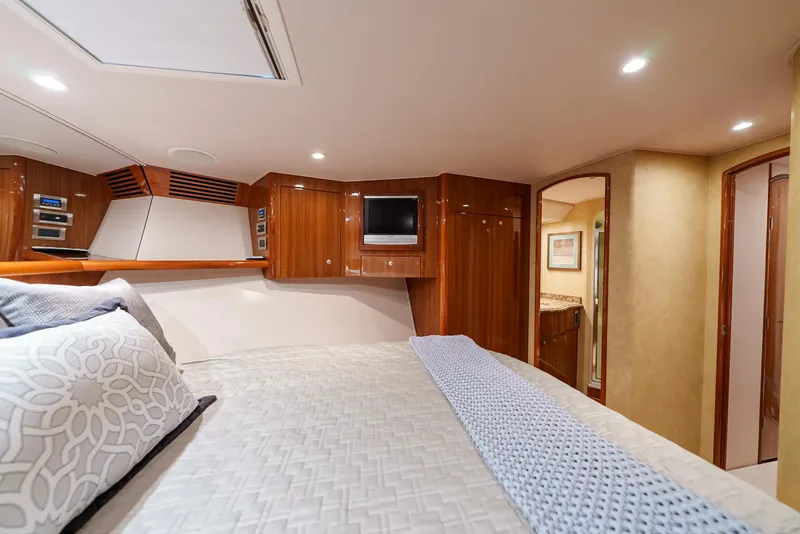 Slide: The Image of Luxurious bedroom interior of 2008 Viking 68 Skybridge yacht with wood paneling and modern amenities. - 31