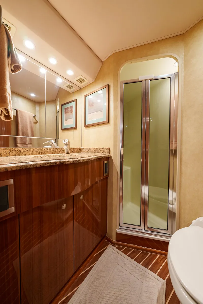 Slide: The Image of Luxurious bathroom in a 2008 Viking 68 Skybridge yacht with a glass shower. - 32