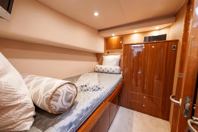 Slide: The Image of Luxurious cabin interior of 2008 Viking 68 Skybridge yacht with wooden cabinetry and cozy bedding. - 34