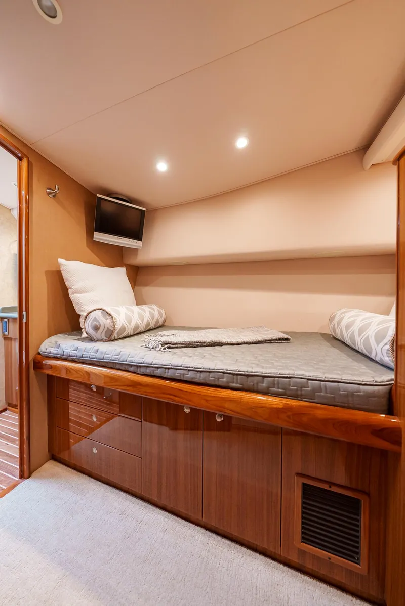 Slide: The Image of 2008 Viking 68 Skybridge cabin with cozy bed and TV. - 37