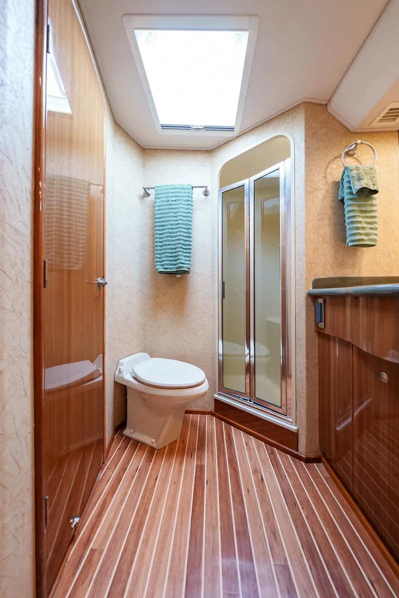 Slide: The Image of Luxurious bathroom in 2008 Viking 68 Skybridge yacht with wooden flooring. - 38
