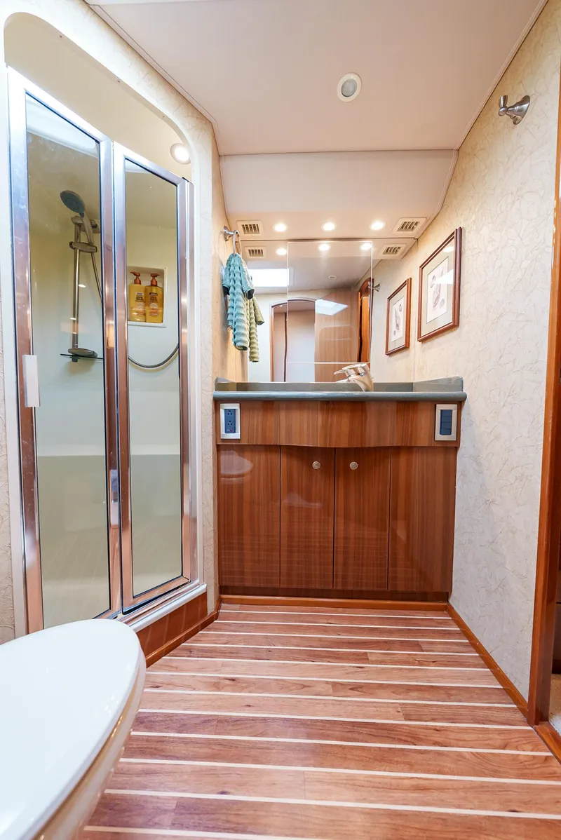 Slide: The Image of Luxurious bathroom in 2008 Viking 68 Skybridge yacht with wooden flooring. - 41