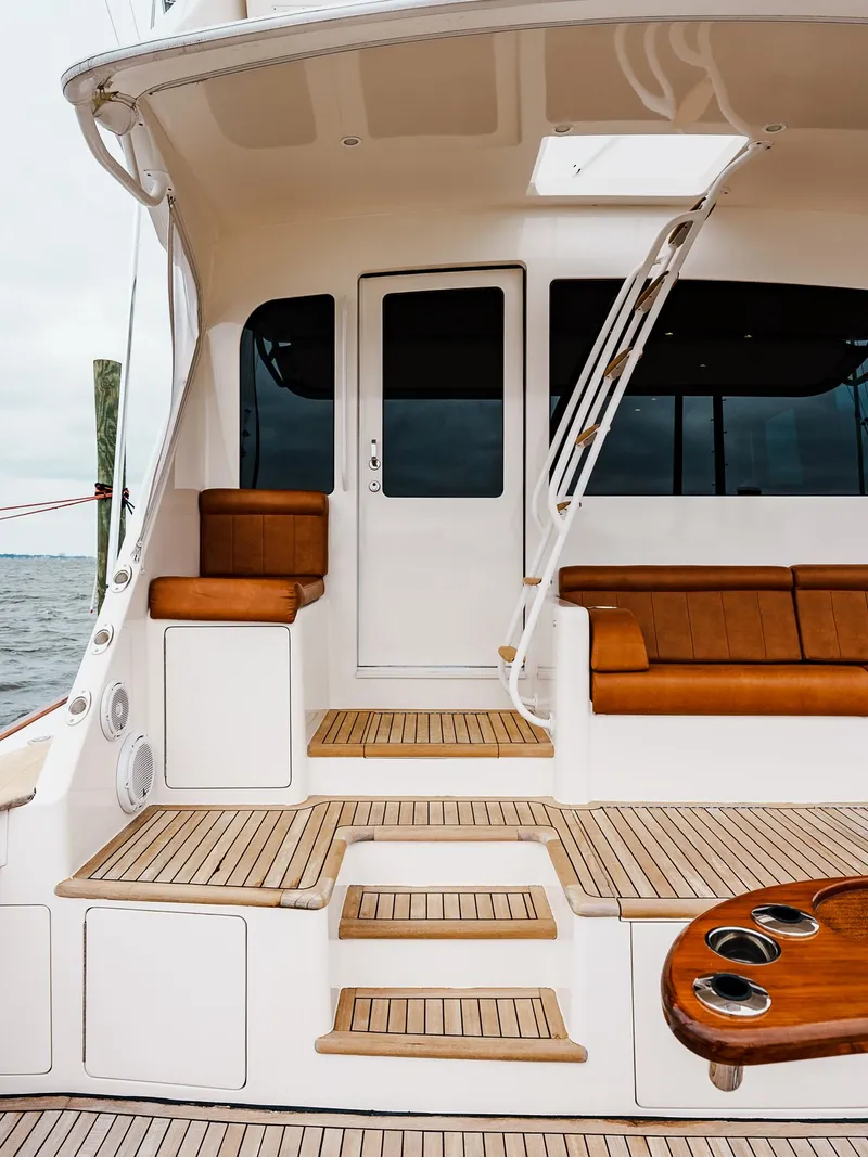 Slide: The Image of Alt text: 2008 Viking 68 Skybridge yacht with teak steps and seating area. - 5