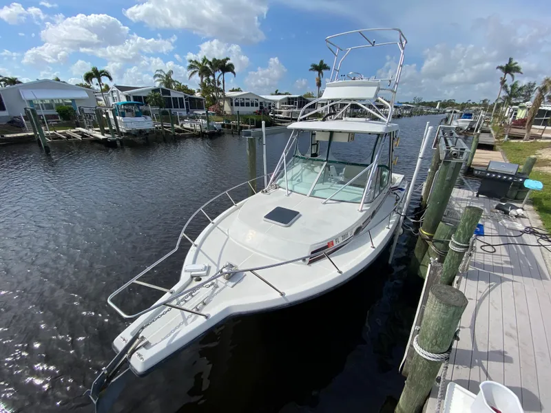 The Image of 1997 Stamas 310 Express boat docked in a sunny marina. - 0