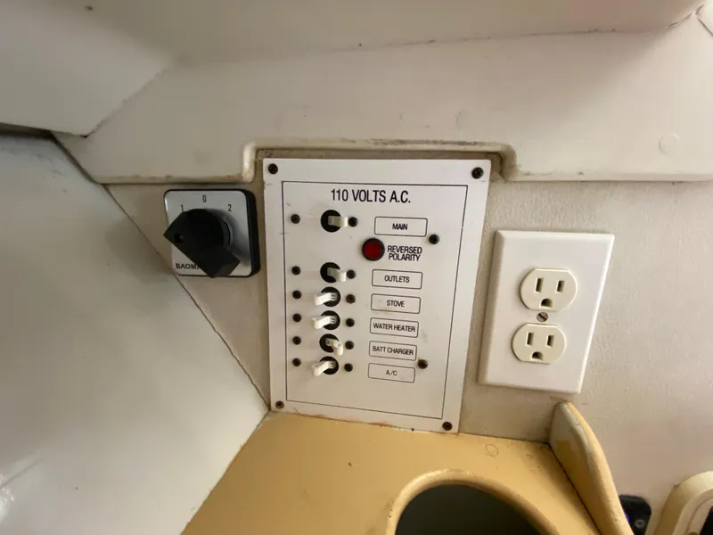 Slide: The Image of 1997 Stamas 310 Express electrical panel with 110 volts AC and power outlets. - 10