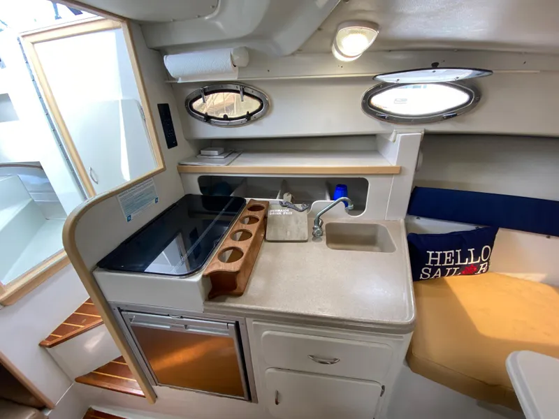 Slide: The Image of 1997 Stamas 310 Express boat interior with kitchenette and seating area. - 12