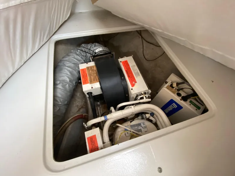 Slide: The Image of Engine compartment of a 1997 Stamas 310 Express boat showing mechanical components. - 17