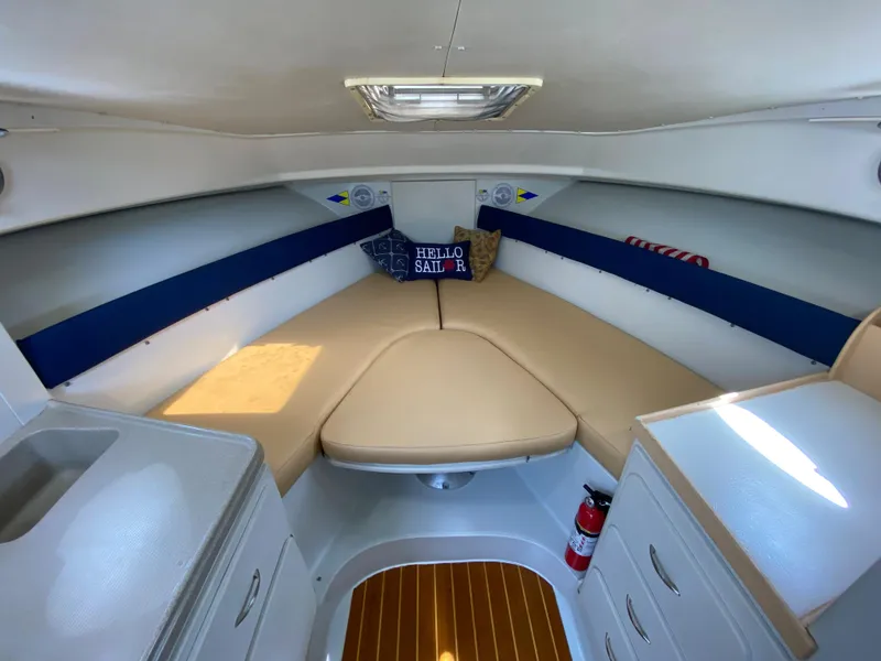 Slide: The Image of 1997 Stamas 310 Express cabin interior with beige seating and nautical decor. - 18