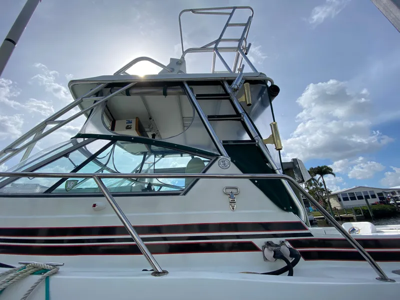 Slide: The Image of 1997 Stamas 310 Express boat with tower and clear skies. - 2