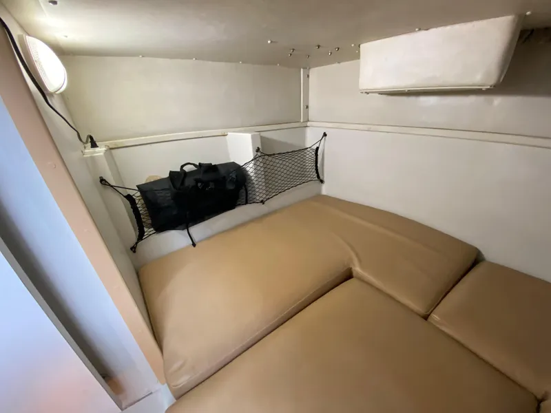 Slide: The Image of 1997 Stamas 310 Express cabin interior with beige cushions and storage net. - 20