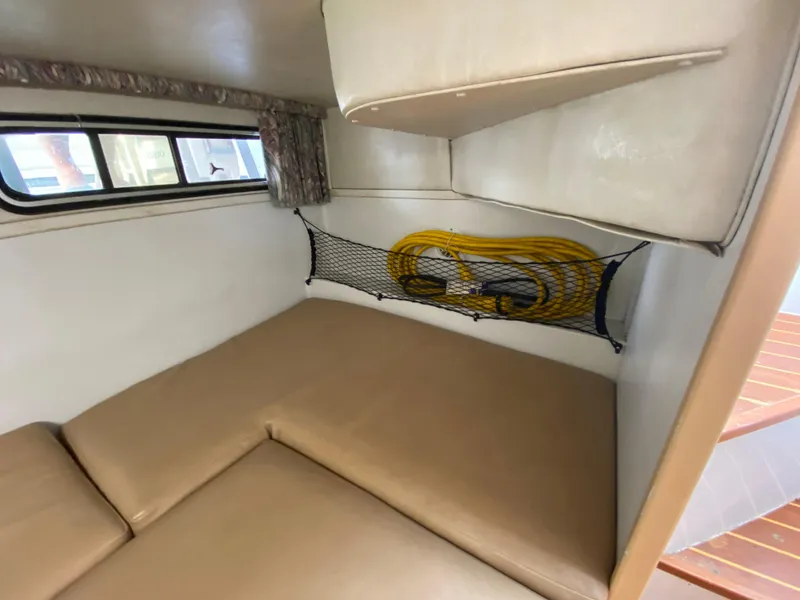 Slide: The Image of 1997 Stamas 310 Express cabin interior with beige cushions and storage net. - 21