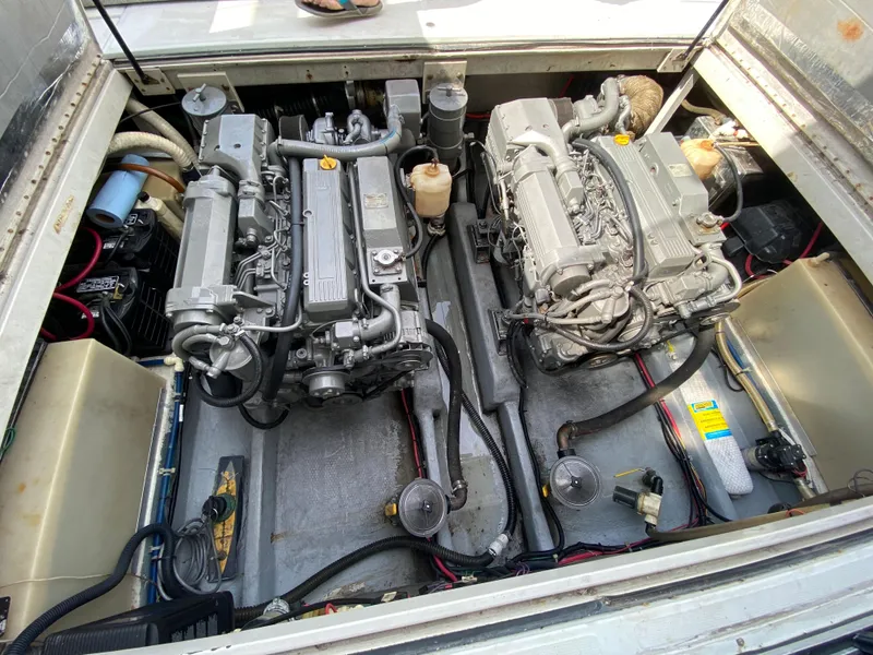 Slide: The Image of 1997 Stamas 310 Express engine compartment with twin inboard engines. - 24