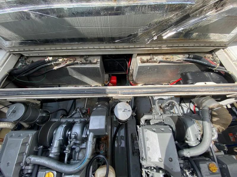 Slide: The Image of Engine compartment of a 1997 Stamas 310 Express boat showing dual engines and wiring. - 25